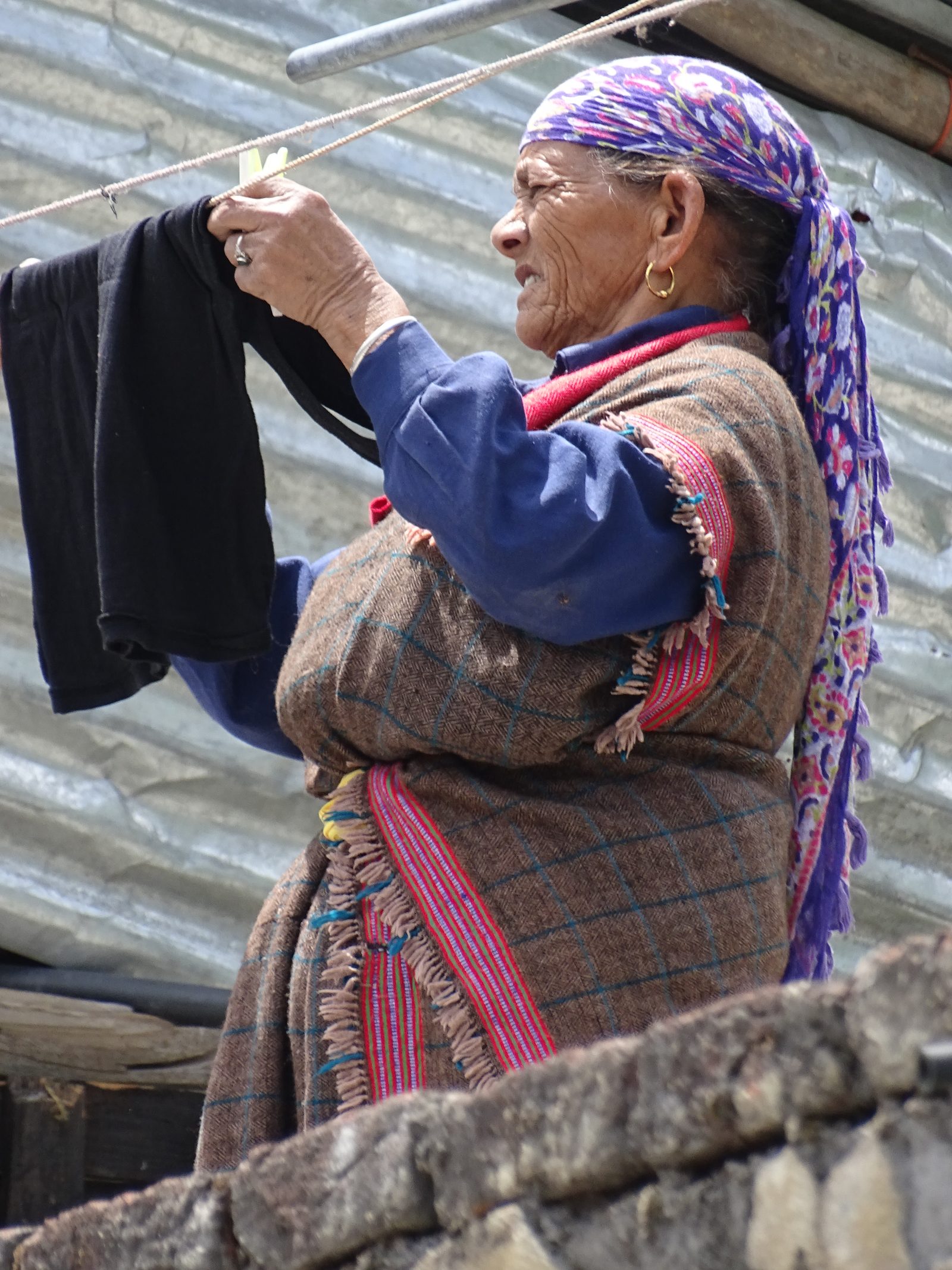A woman hangs the washing in Manali, Himachal Pradesh. Domestic labour does not end at sixty